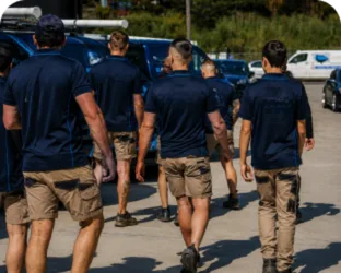 Plumbers walking to their service vans on a Wahroonga job